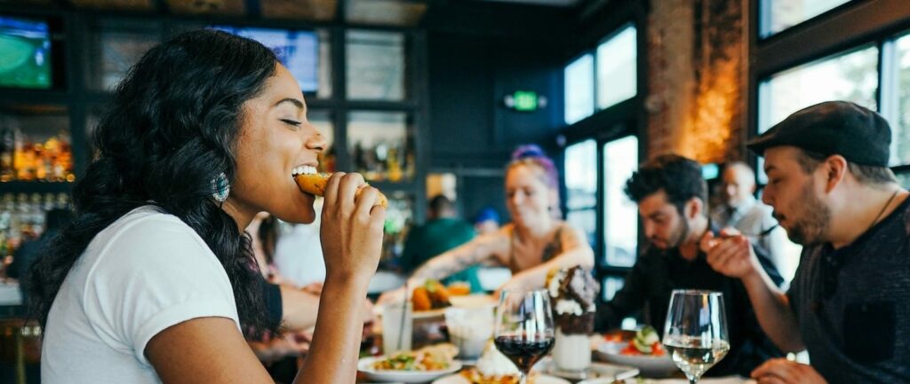 Ragazza che mangia in compagnia da Viva